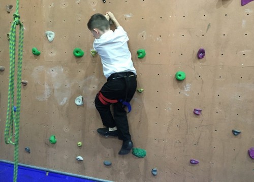 child on climbing wall